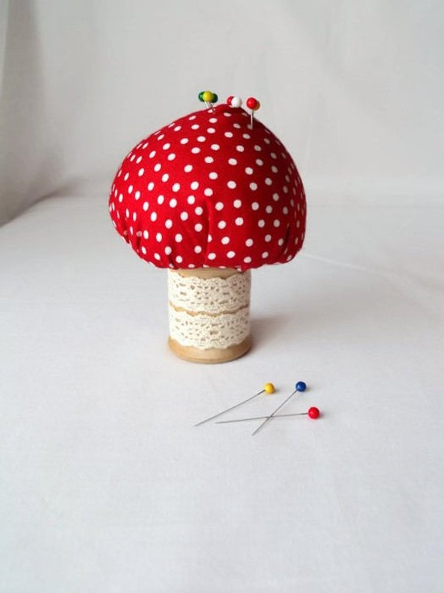 novelty toadstool pin cushion on a vintage wooden bobbin