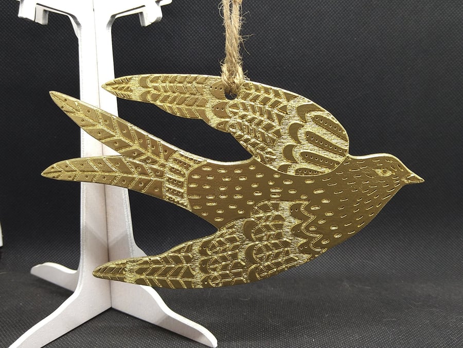 Swallow, hand-drawn and painted gold, laser-etched and laser cut out of wood