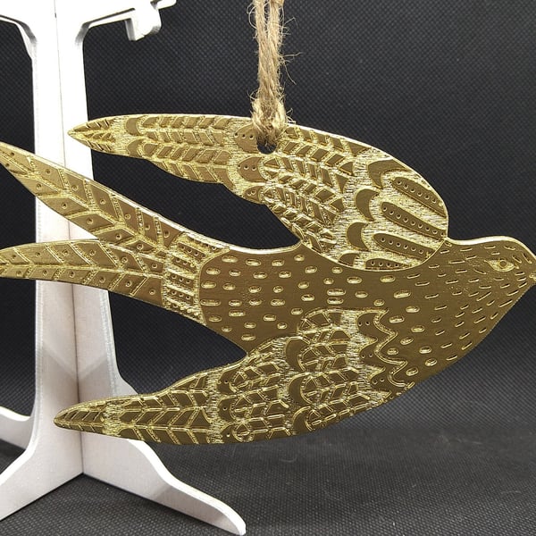 Swallow, hand-drawn and painted gold, laser-etched and laser cut out of wood