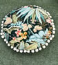 Round feature cushion in vintage leafy linen with pompoms - Image 8