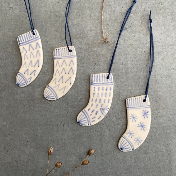 Set of four ceramic sock decorations .