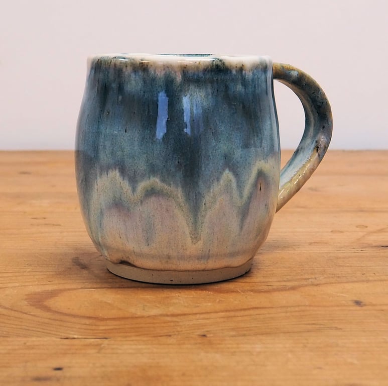 Pottery mug finished in multi-coloured blue and cream glaze, handmade