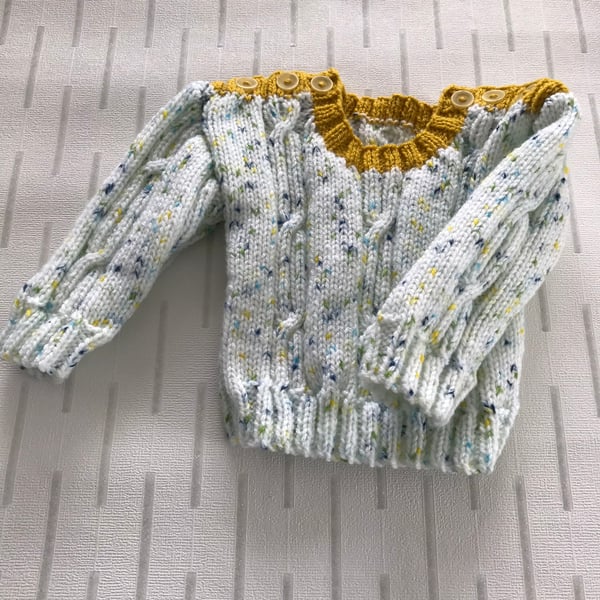 Speckled jumper with cable panels
