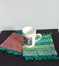 44. A Pair Of Handwoven Mug Mats