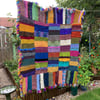 Multicoloured chunky hand knitted blanket
