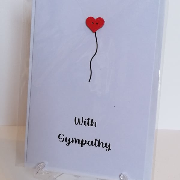 With Sympathy card with a red heart button