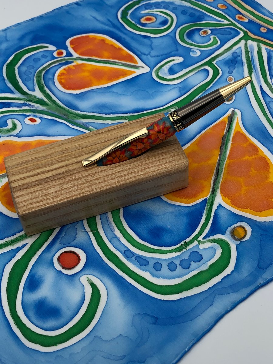 Elegant, Orange flowered barrel, twist action,  pen in ash stand