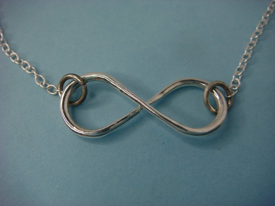 Infinity pendant with sterling silver trace chain