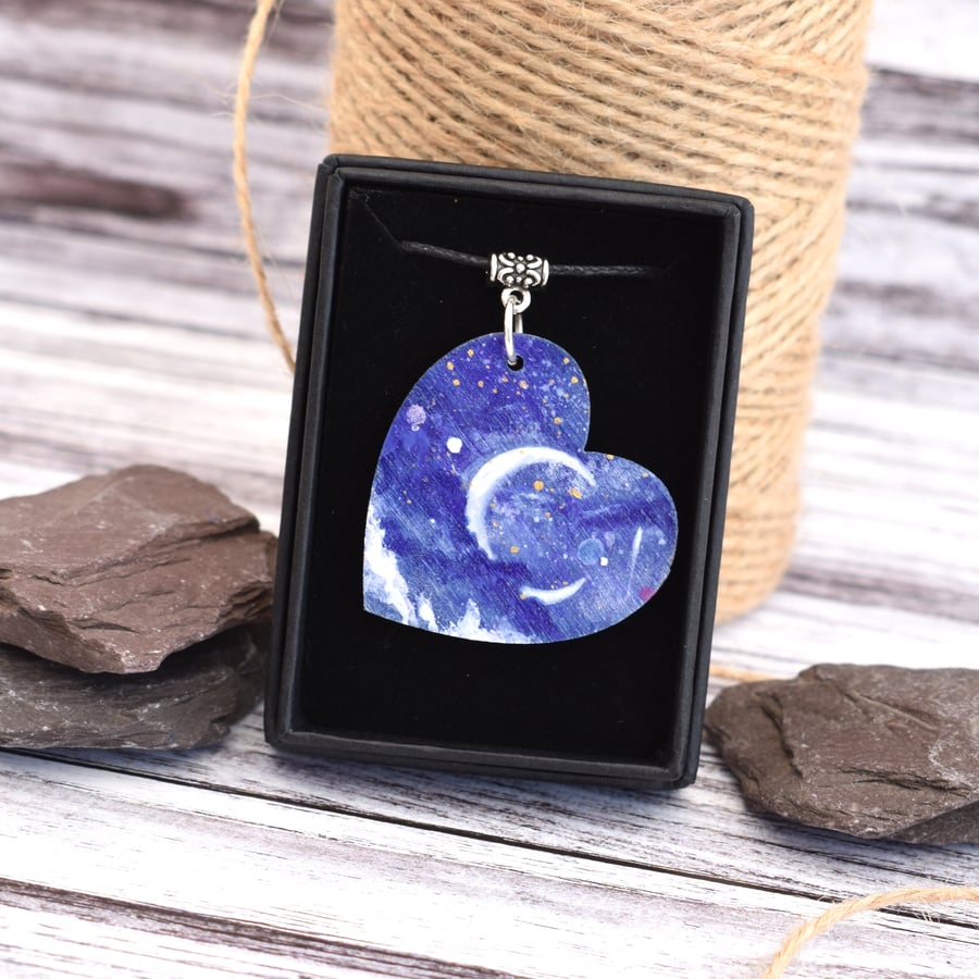 Fairytale skies. Wooden heart pendant with a crescent moon and planets.
