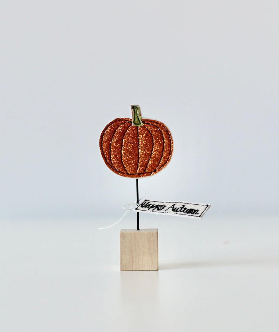 A 'Happy Autumn' Glittery Pumpkin with a Wire Stem & Wooden Block Stand