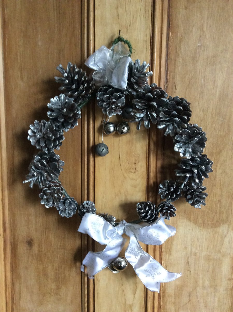 Silver wreath with fir cones and bells 