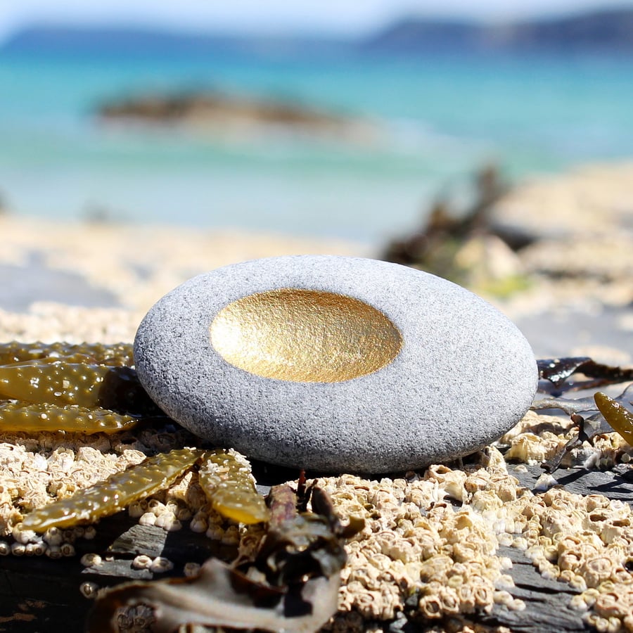 Pebble pendant with golden recess, designed by contemporary jeweller John Field.