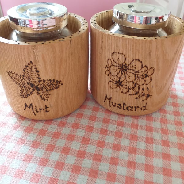 Two condiments  jars set in wood