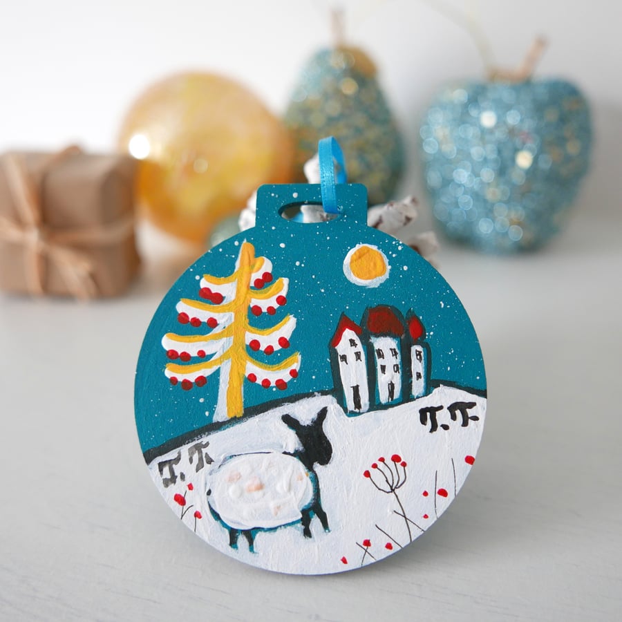 Blue Christmas Decoration with Cottage and Sheep in a Winter Wonderland setting