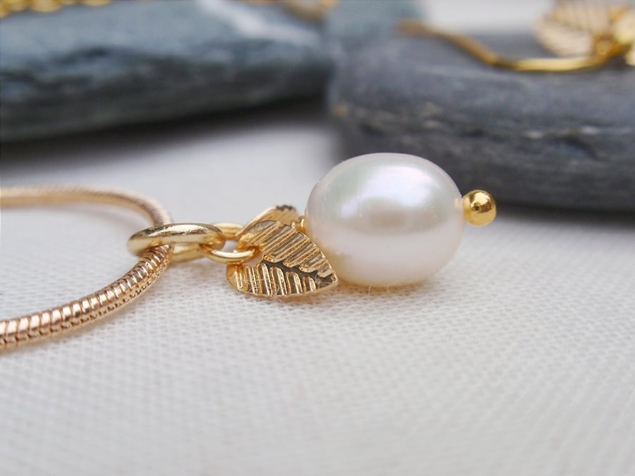 Gold plated pearl necklace with tiny leaves