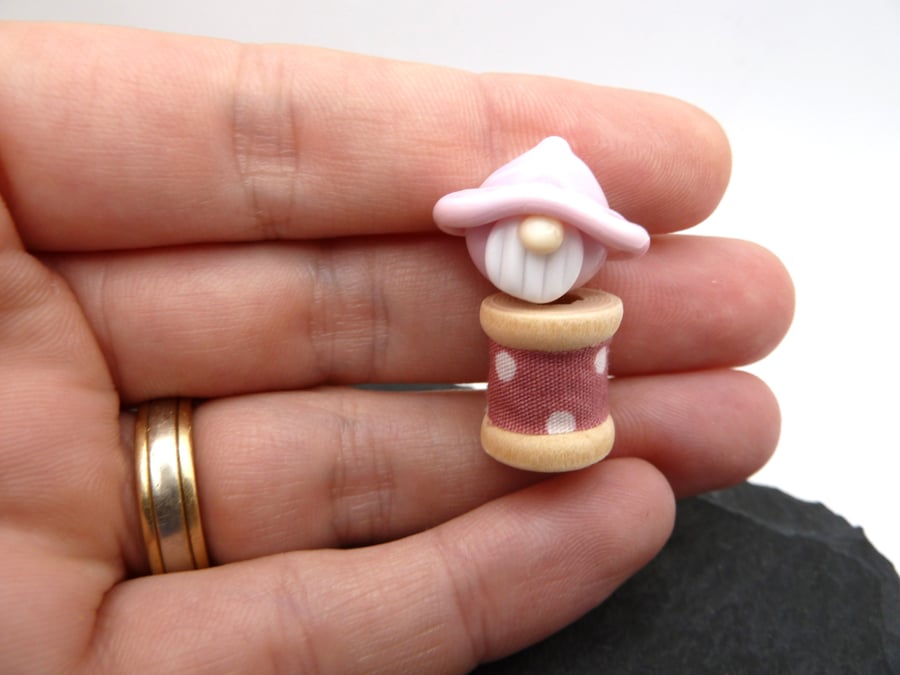 small glass bobbin, pink gnome