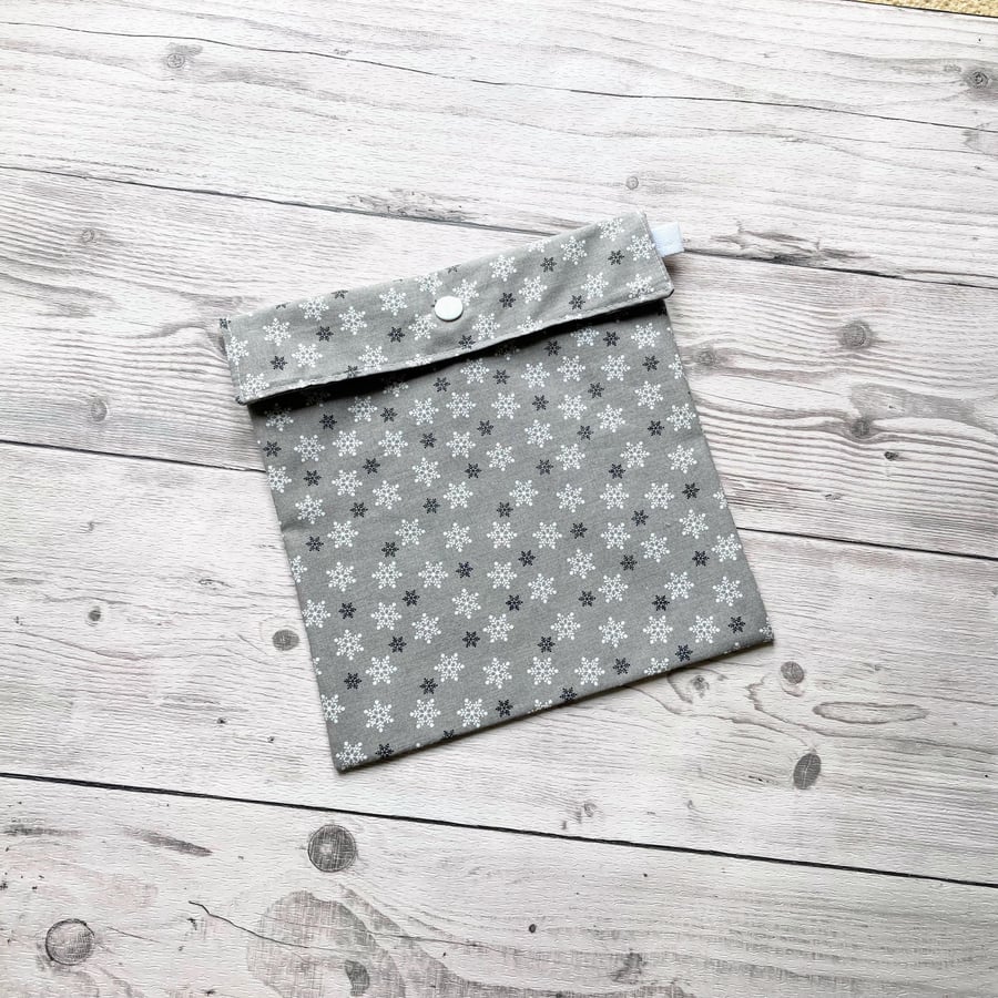 Snowflake Christmas themed silver cotton fabric gift bags with snap closure. 