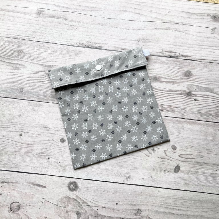 Snowflake Christmas themed silver cotton fabric gift bags with snap closure. 