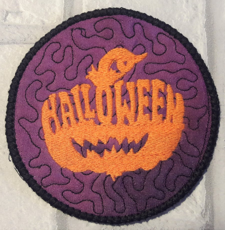 Halloween themed coaster with pumpkin design