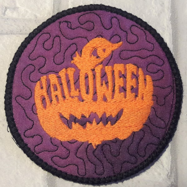 Halloween themed coaster with pumpkin design