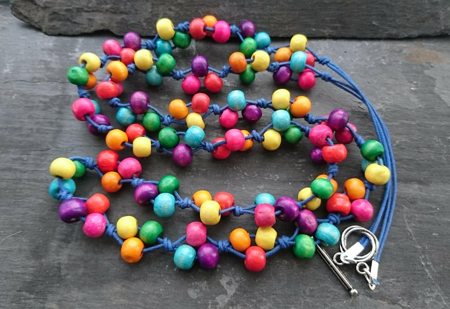 Rainbow coloured wooden bead longer length necklace on blue cord