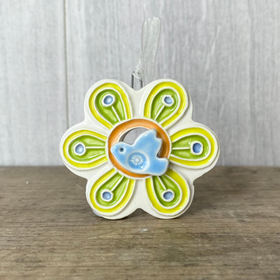 Intricate ceramic flower decoration with bird yellow