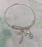 Silver plated charm bangle with green angelite and selenite stones - Image 1