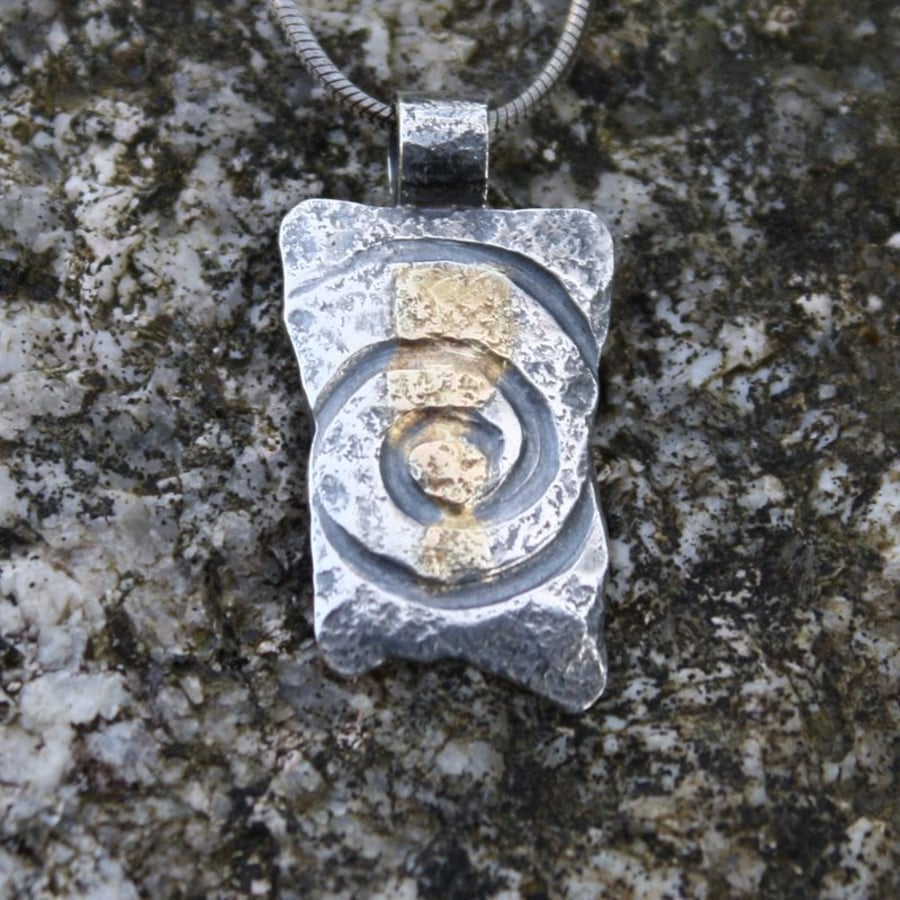 Silver Spiral pendant with 18ct gold detail.