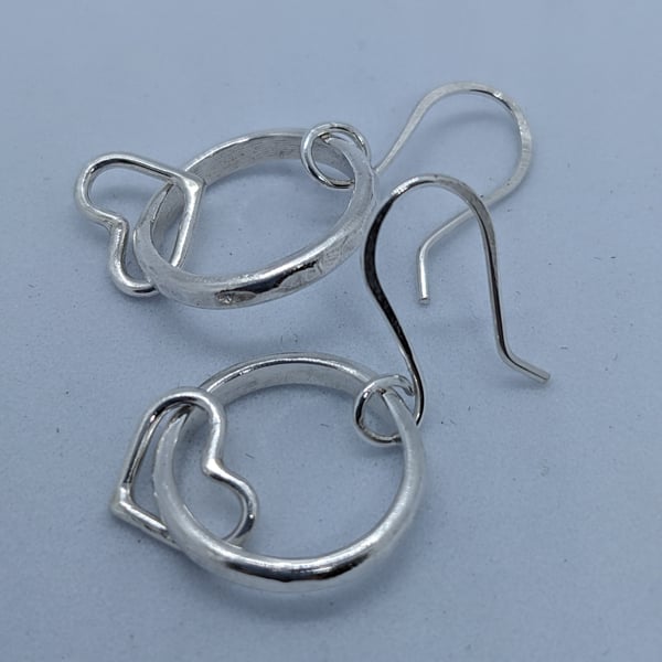 Handmade silver hoop earrings with hearts