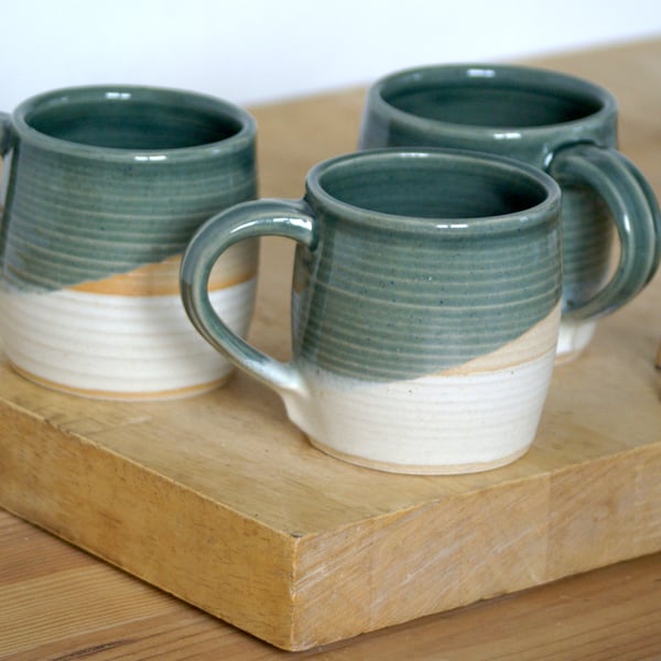 Pair of cozy stoneware pottery tea mugs glazed in ice blue and vanilla