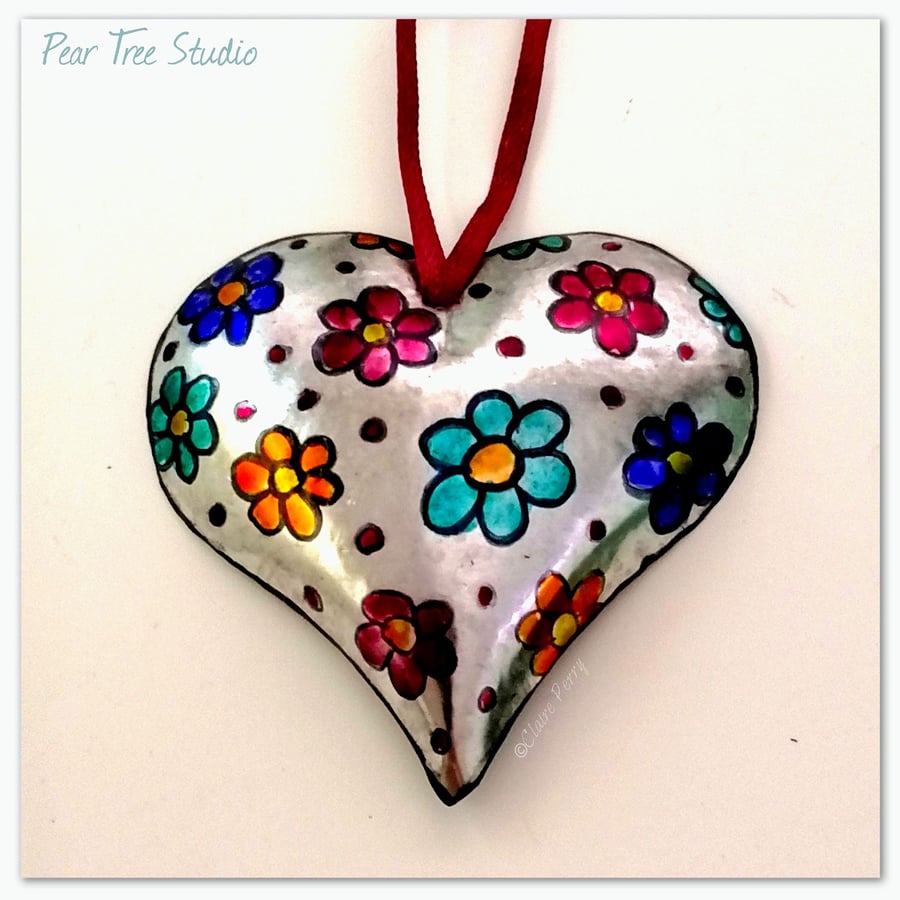Small metal heart decoration with a multi coloured flower pattern. Hand made.