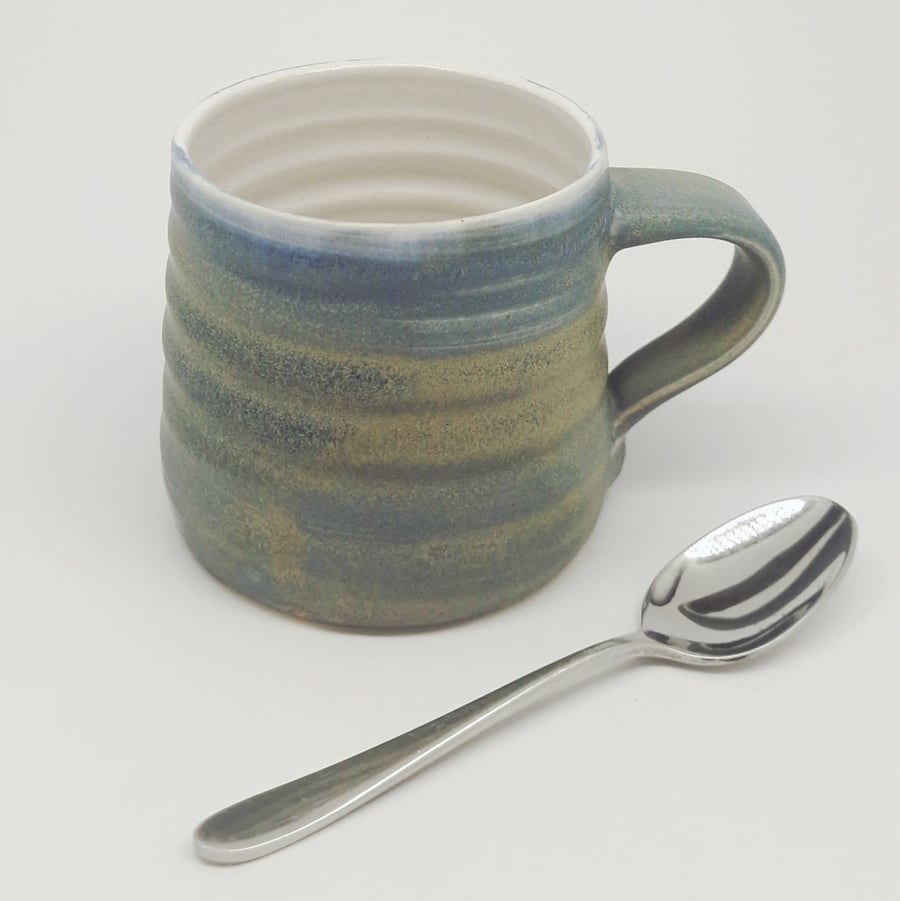 Hand-thrown, stoneware mug in "granite" glaze with a white liner M66