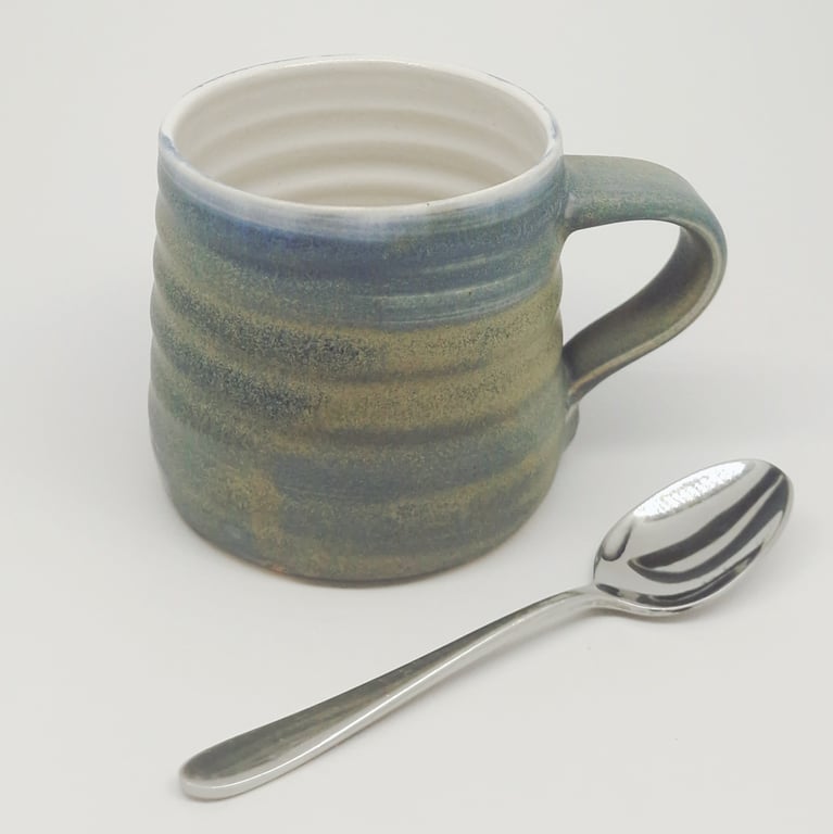 Hand-thrown, stoneware mug in "granite" glaze with a white liner M66