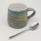 Hand-thrown, stoneware mug in "granite" glaze with a white liner M66