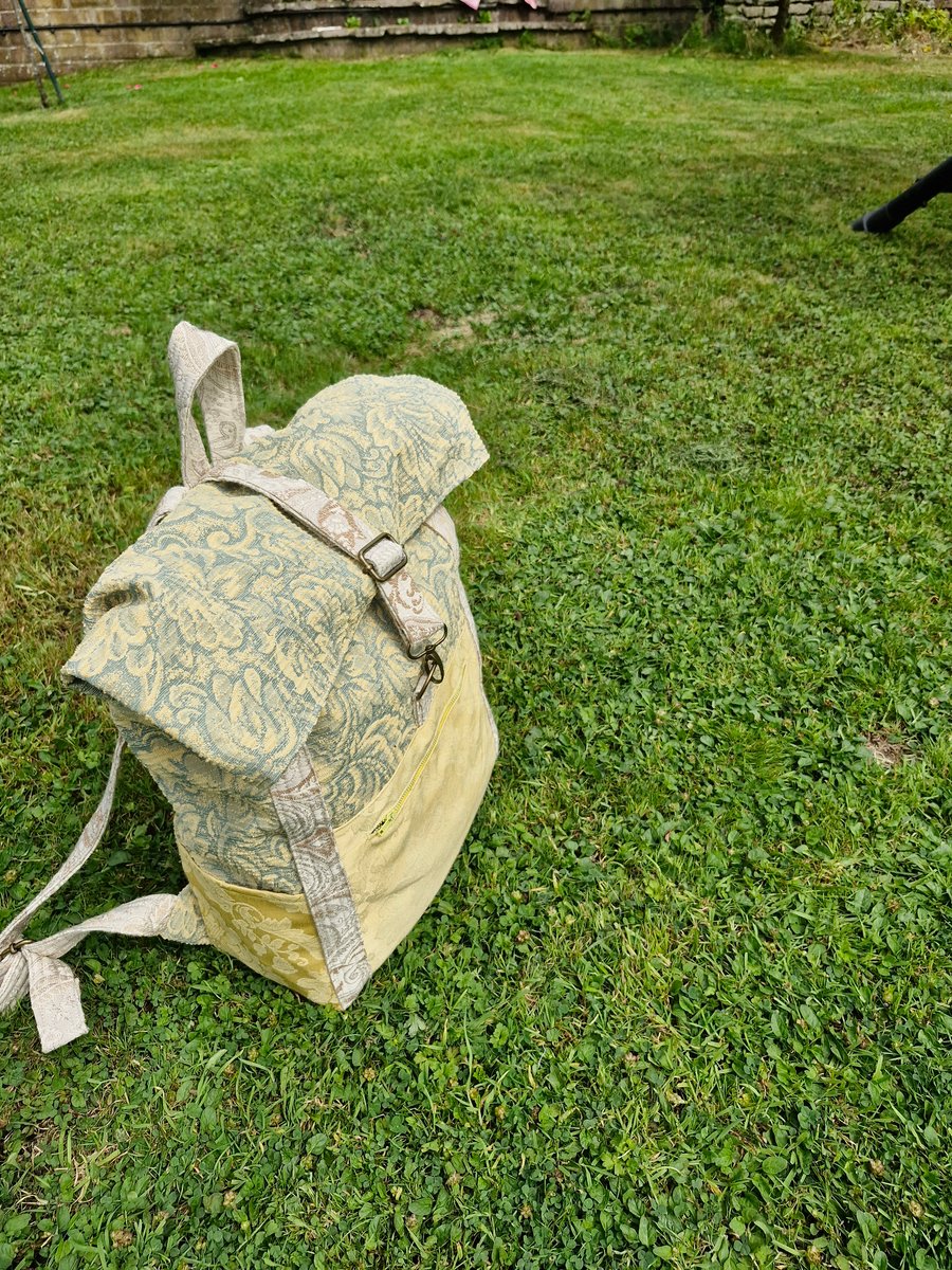 Roomy green and yellow backpack or rucksack with pockets and metal fastenings