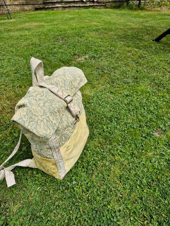 Roomy green and yellow backpack or rucksack with pockets and metal fastenings