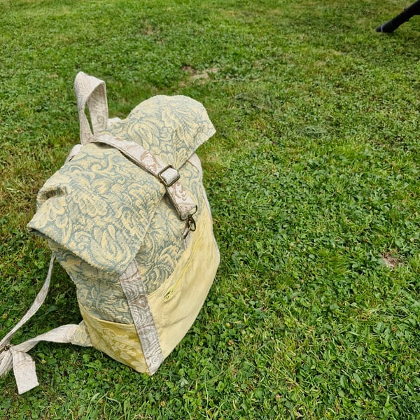 Roomy green and yellow backpack or rucksack with pockets and metal fastenings