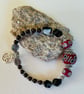 Capricorn January birthday charm bracelet featuring garnet and onyx