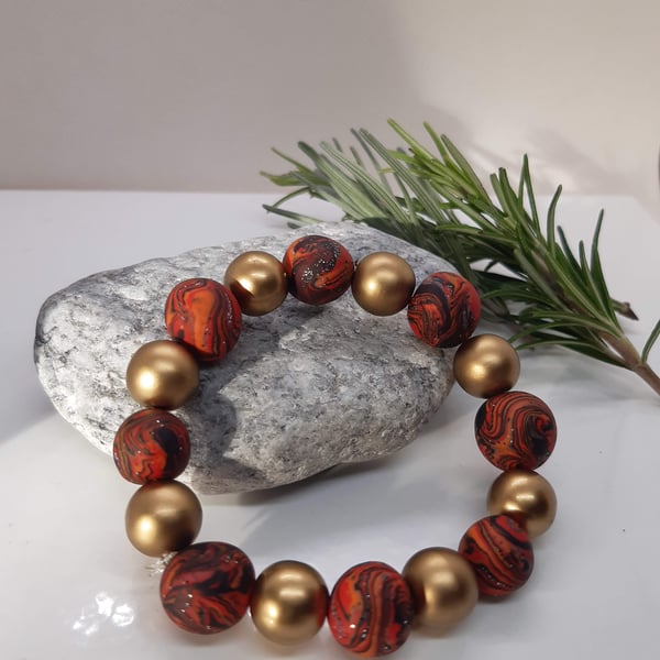 Red, orange and gold polymer clay bracelet