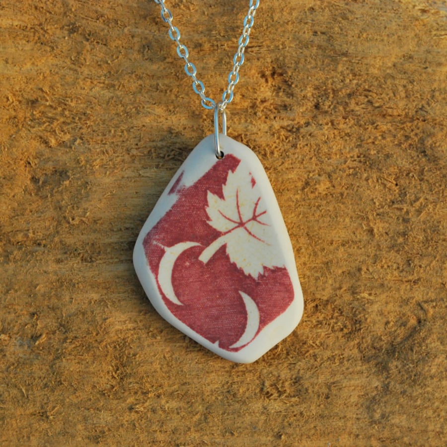 Two moons and a leaf beach pottery pendant
