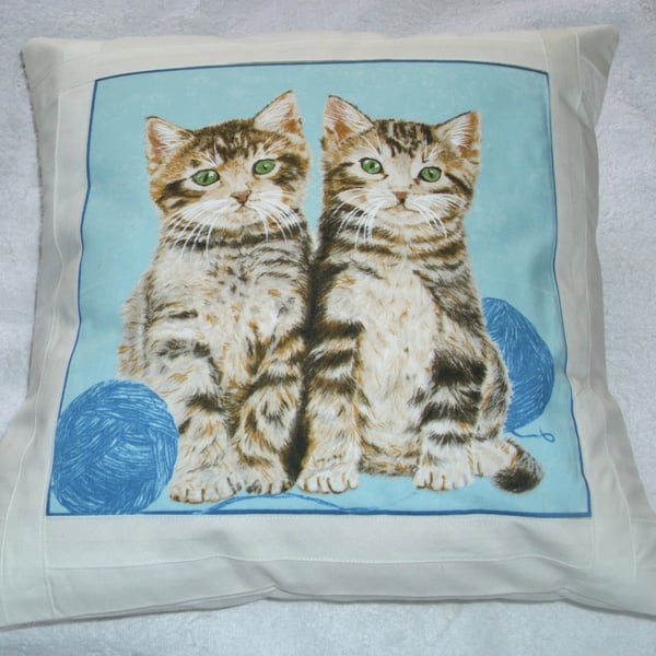 Pretty tabby kittens with balls of wool cushion