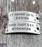 "It never gets easier, you just get stronger" Hand Stamped Trainer Tags - Image 1