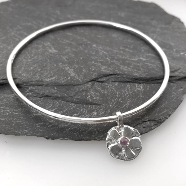Sterling silver bangle with amethyst set flower charm