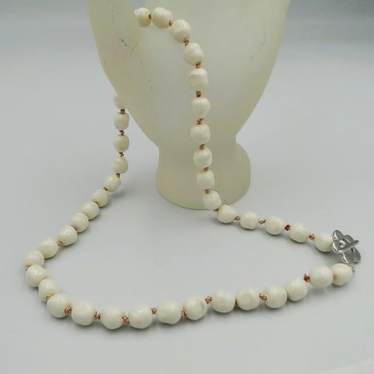 Cream pearl necklace  Traditionally knotted with pink silk thread 
