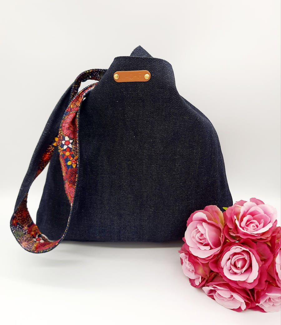 Denim and raspberry pink dandelion burst reversible knot bag. 