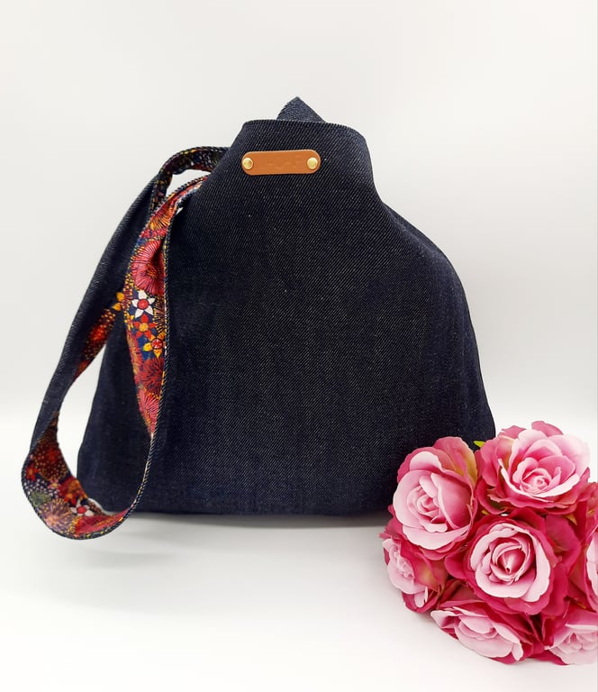 Denim and raspberry pink dandelion burst reversible knot bag. 