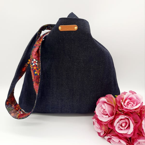 Denim and raspberry pink dandelion burst reversible knot bag. 