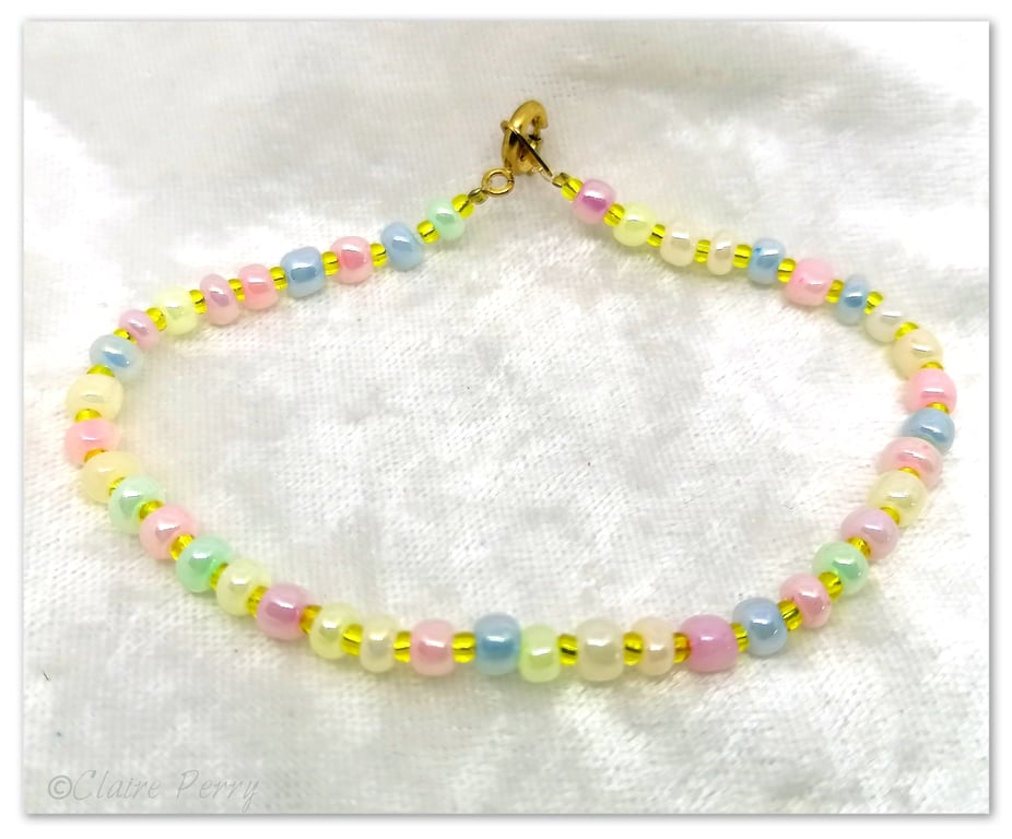 Seed bead bracelet with pastel coloured glass beads.