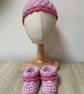 Pink baby hat and bootie set.