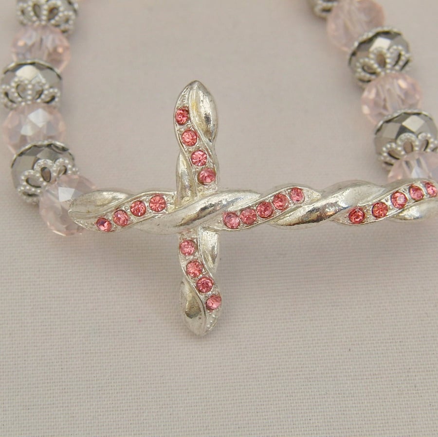 Silver Plated Cross with Pink Rhinestones on a Pink and Silver Crystal Bracelet